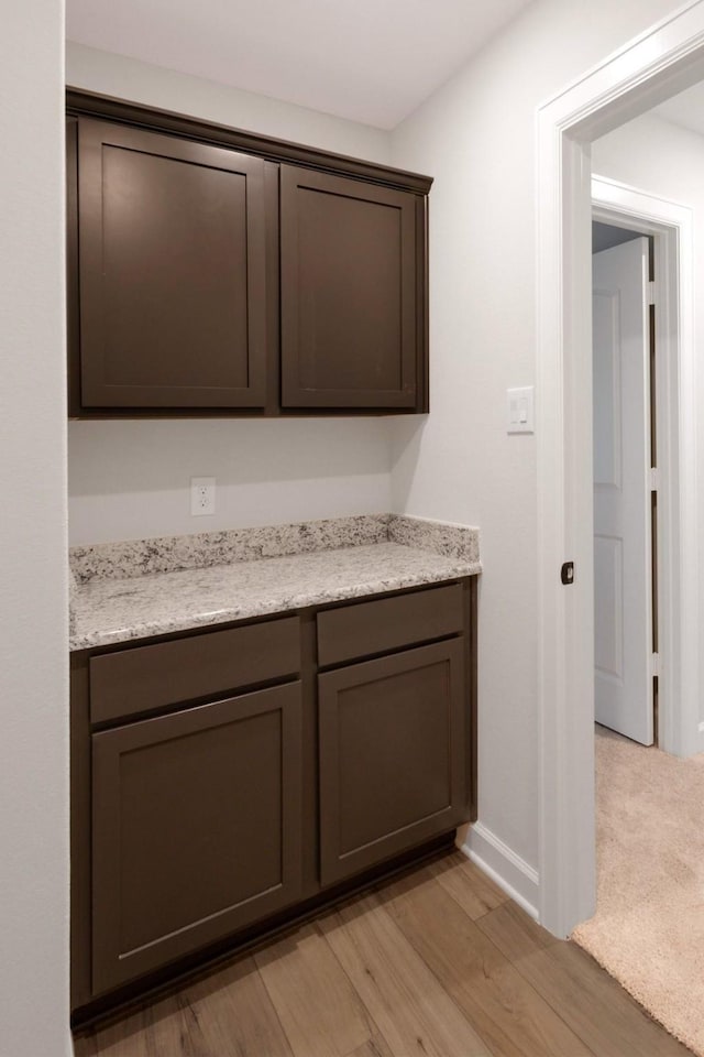 interior space with vanity and wood-type flooring