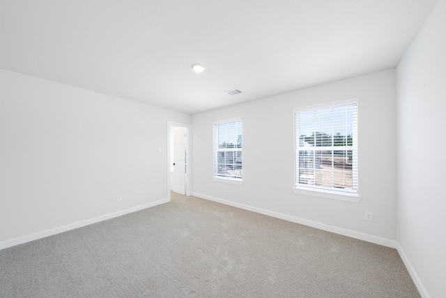 unfurnished room with light carpet