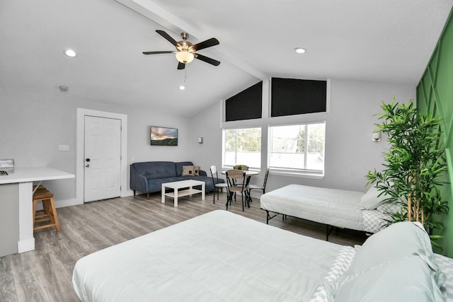 bedroom featuring vaulted ceiling with beams, hardwood / wood-style flooring, and ceiling fan