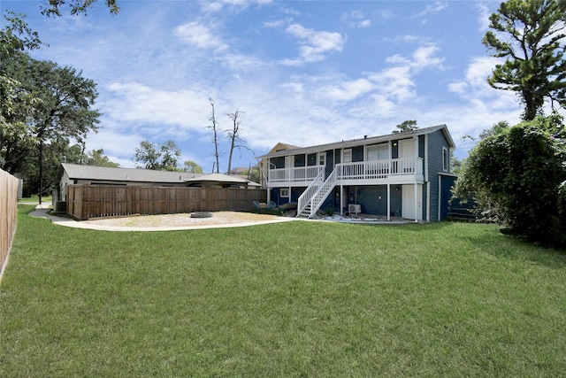 rear view of house with a sunroom and a yard