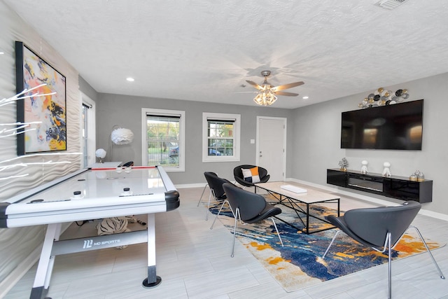 interior space featuring ceiling fan and a textured ceiling