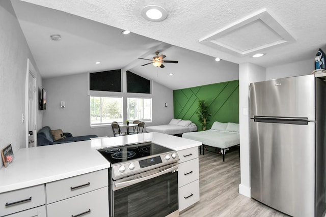 kitchen featuring appliances with stainless steel finishes, light wood-type flooring, a textured ceiling, ceiling fan, and white cabinetry