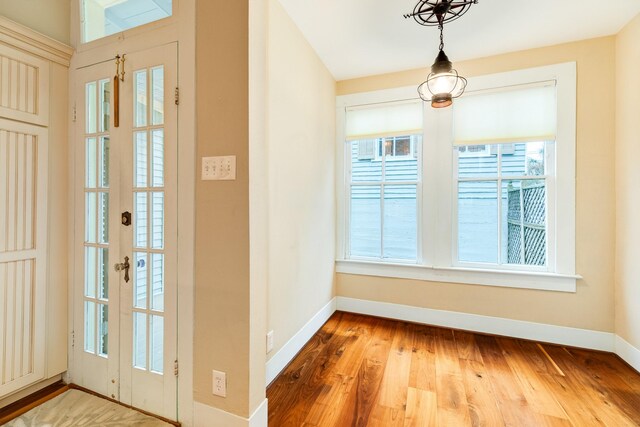 foyer entrance with wood-type flooring and french doors