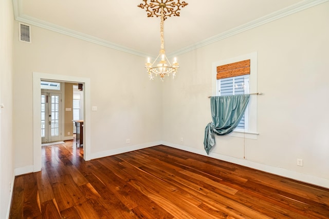 unfurnished room featuring crown molding, dark hardwood / wood-style floors, and an inviting chandelier