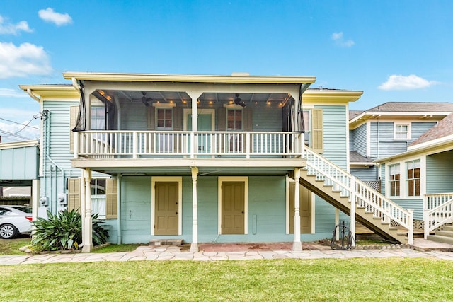 view of front of property with a front yard and ceiling fan