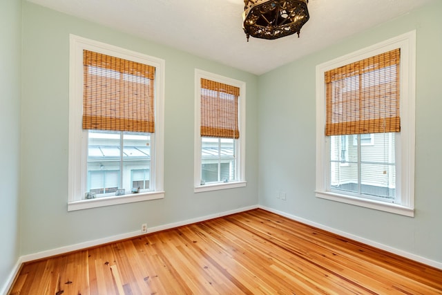 unfurnished room with wood-type flooring