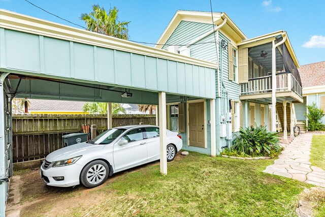 view of front of house featuring a front lawn and a carport