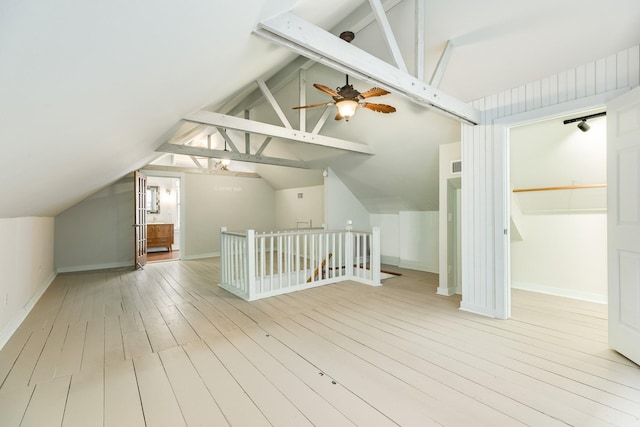 bonus room featuring lofted ceiling with beams, ceiling fan, and light wood-type flooring