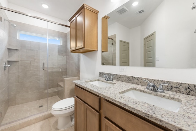 bathroom featuring vanity, tile patterned floors, a shower with shower door, and toilet