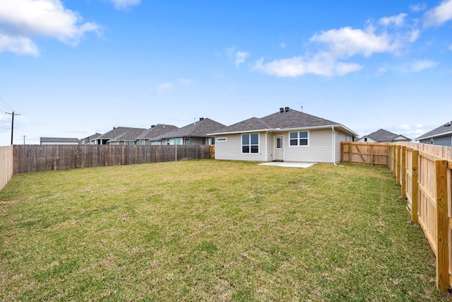 rear view of house featuring a patio and a lawn