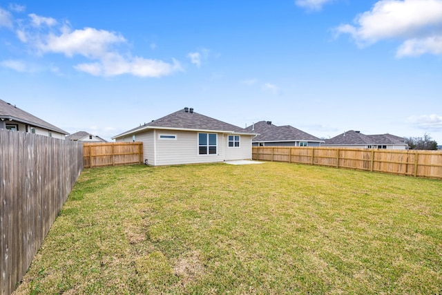 back of house featuring a yard and a patio area