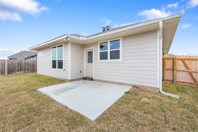 rear view of house with a patio area and a yard