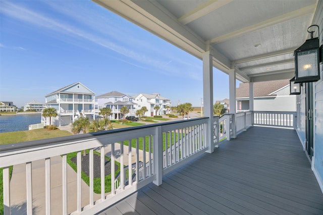 deck with a residential view and a water view