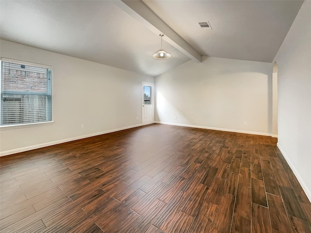 unfurnished room with vaulted ceiling with beams