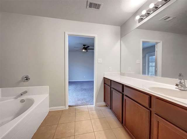 bathroom featuring vanity, tile patterned floors, ceiling fan, and a bathing tub