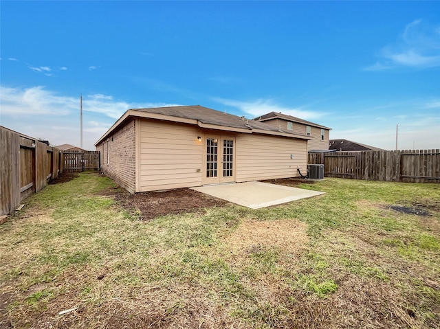 rear view of property featuring central AC, a yard, and a patio