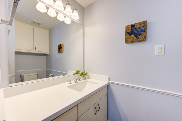 bathroom featuring toilet and vanity