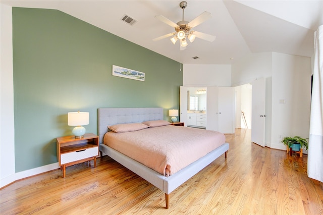 bedroom with ceiling fan, light hardwood / wood-style floors, and lofted ceiling