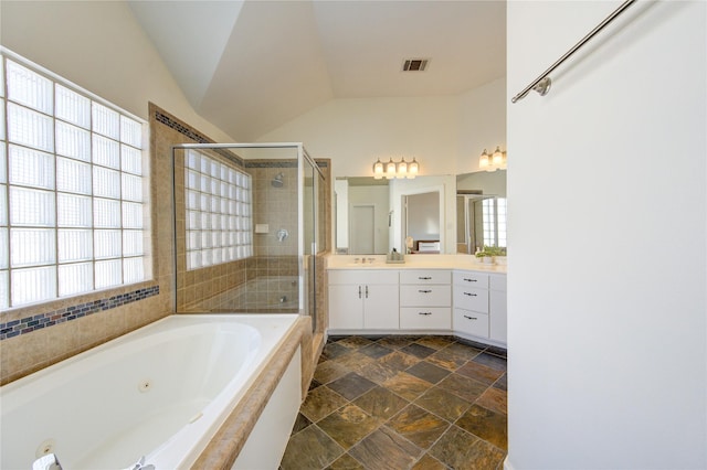 bathroom with lofted ceiling, vanity, and separate shower and tub