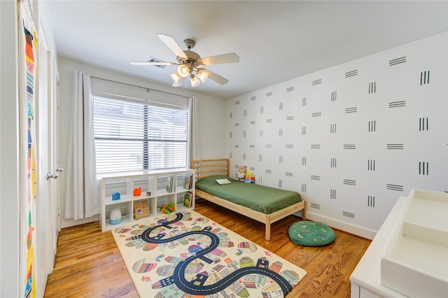 bedroom featuring ceiling fan and light wood-type flooring