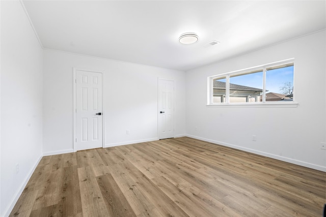 spare room with light wood-type flooring