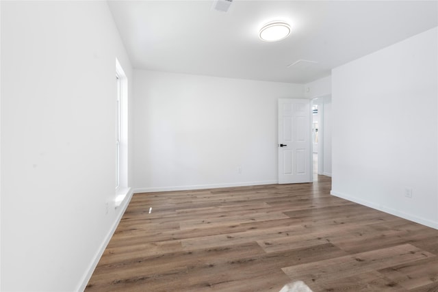 spare room with hardwood / wood-style flooring