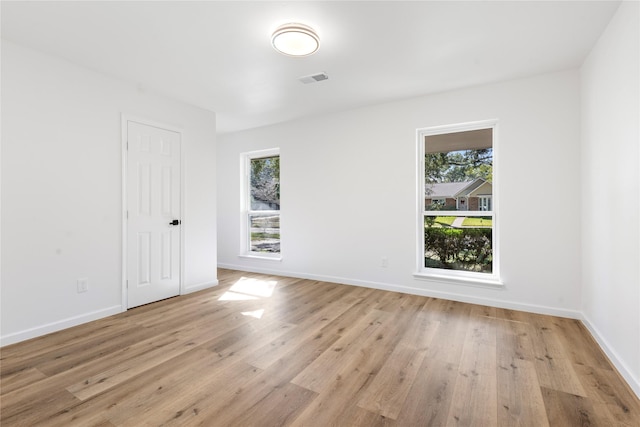 unfurnished room with light hardwood / wood-style flooring