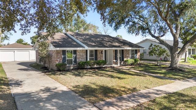 ranch-style home with a porch, a front lawn, an outdoor structure, and a garage