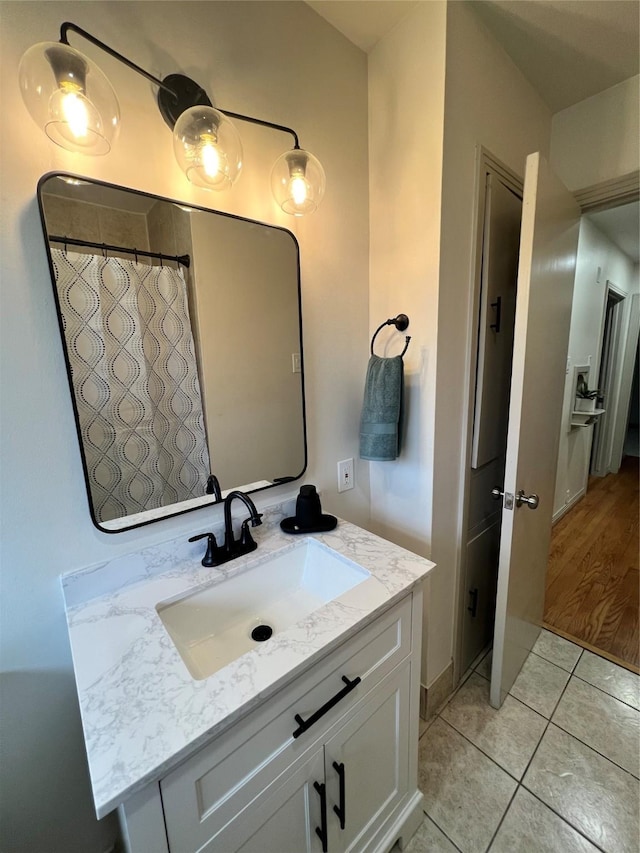 bathroom with tile patterned flooring, vanity, and curtained shower