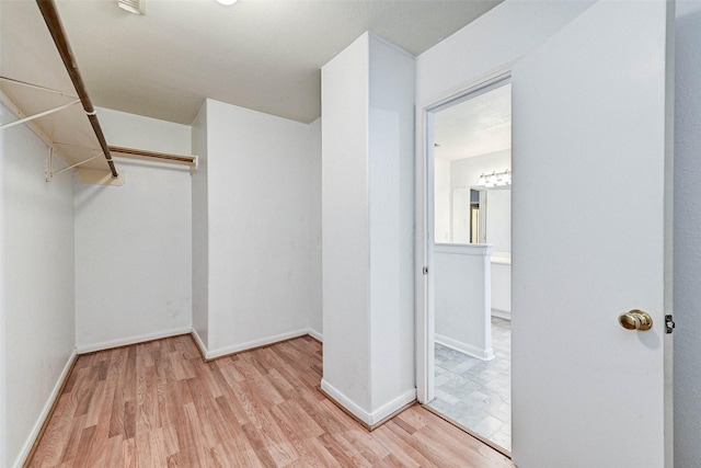 spacious closet featuring light wood-type flooring