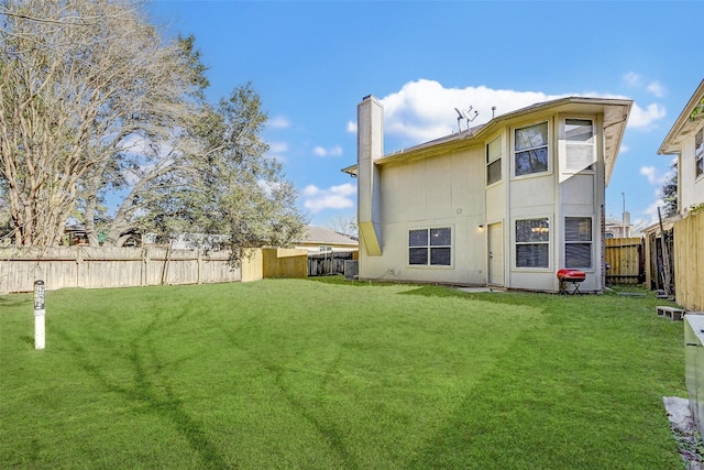 rear view of house featuring a yard