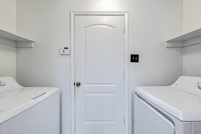 clothes washing area featuring washing machine and dryer