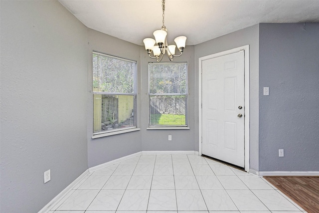 interior space featuring light tile patterned floors and a notable chandelier