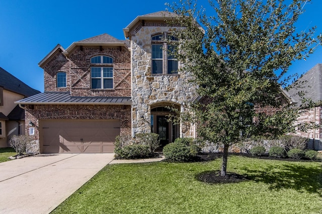 view of front of home with a garage and a front lawn