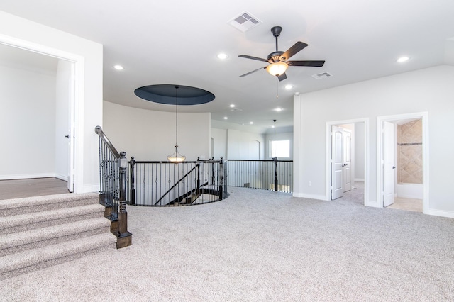 staircase with carpet flooring and ceiling fan