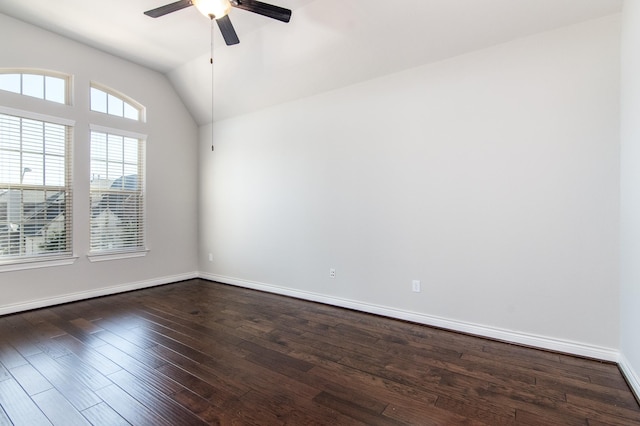 empty room with dark hardwood / wood-style floors, vaulted ceiling, and ceiling fan