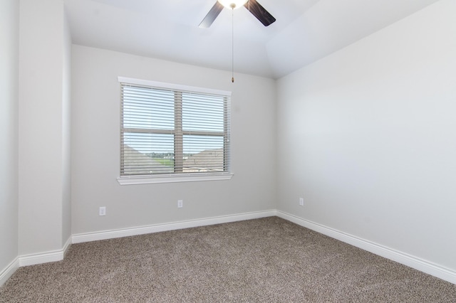 carpeted spare room with ceiling fan and lofted ceiling