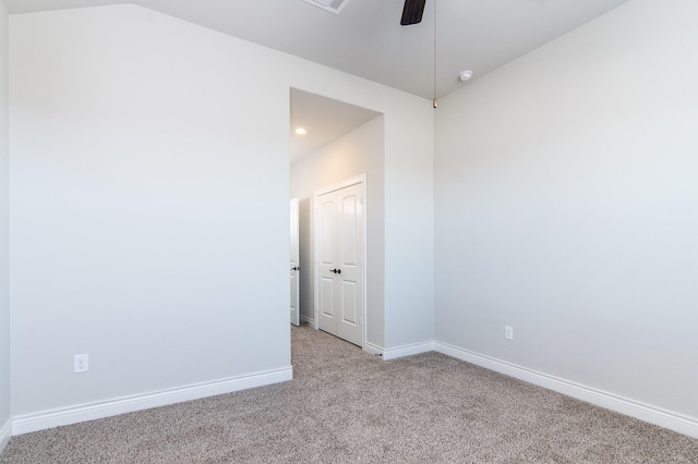 carpeted spare room with ceiling fan and lofted ceiling