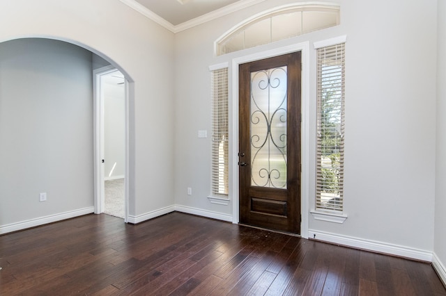 foyer entrance with dark hardwood / wood-style floors and crown molding