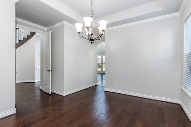 unfurnished dining area with dark hardwood / wood-style flooring, ornamental molding, and an inviting chandelier