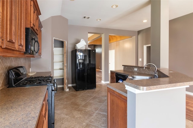 kitchen with light tile patterned flooring, sink, lofted ceiling, and black appliances