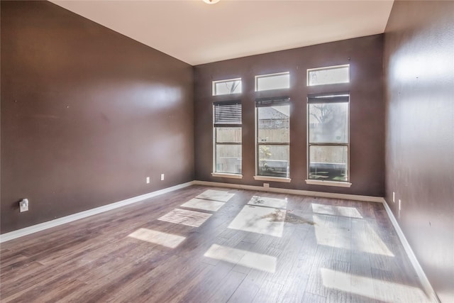 unfurnished room with hardwood / wood-style floors and a wealth of natural light