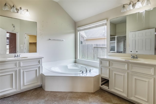 bathroom featuring plus walk in shower, vanity, and vaulted ceiling