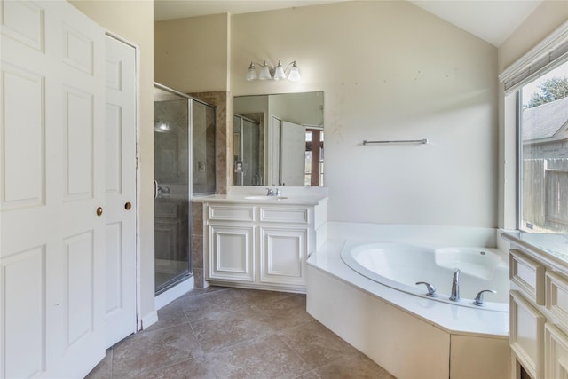 bathroom with vanity, independent shower and bath, and vaulted ceiling