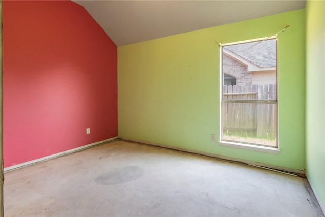 unfurnished room featuring lofted ceiling