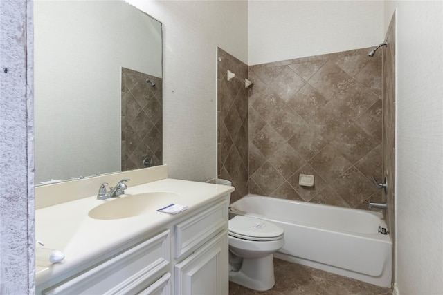 full bathroom featuring vanity, toilet, and tiled shower / bath