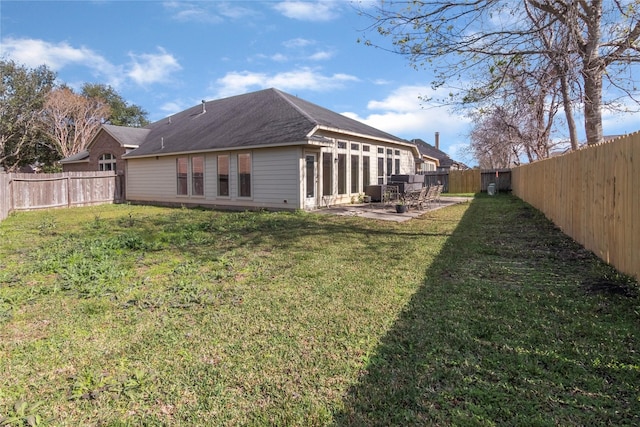 rear view of property featuring a yard and a patio