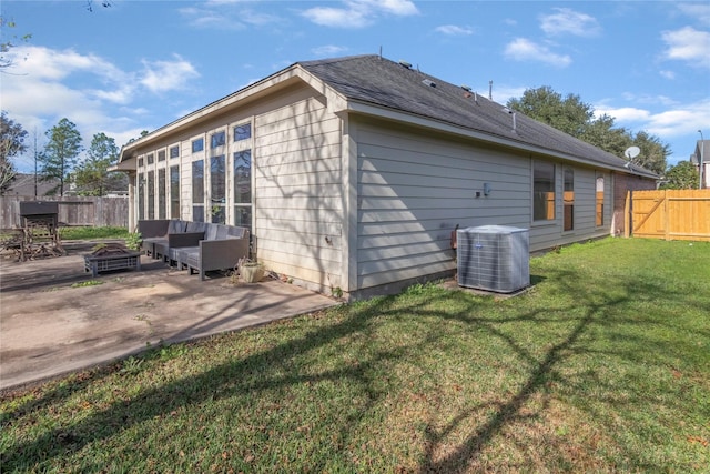 back of property featuring an outdoor living space with a fire pit, central AC, a yard, and a patio