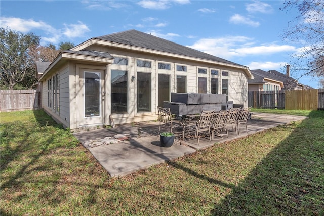 back of house featuring a lawn and a patio