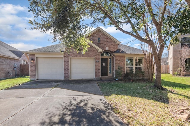 view of front of property featuring a front yard and a garage